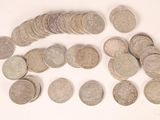 a pile of silver coins on a white surface