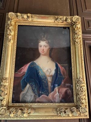 peinture d'une femme en robe bleue dans un cadre doré