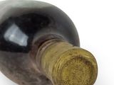 a bottle of wine that is sitting on a white surface
