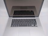 an open laptop computer sitting on top of a white table