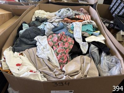a cardboard box full of clothes on a table