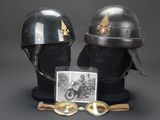 two helmets and goggles on display with a picture of a man on a motorbike