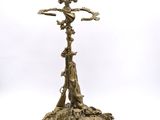 a gold plated candle holder with a bird on top of it