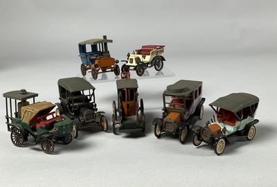 several toy cars are lined up in a row on a white surface