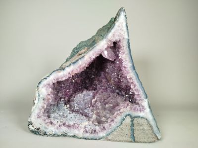 a close up of a piece of rock with purple crystals