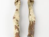 two pieces of wood with peeling paint on them on a white surface