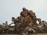 a gold frame with a clock on top of it