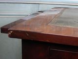 a close up of a wooden table with a bird on it