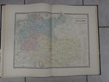 an open book on a tiled floor with a map on it