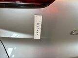 a sticker on the back of a silver car