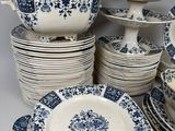 many blue and white plates and bowls on the table