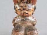 figurine représentant un homme coiffé d’un chapeau