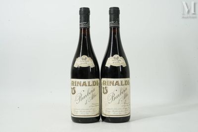two bottles of wine sitting next to each other on a white surface