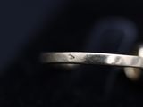 a close up of a ring with a diamond on it