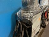 a blue wall with a bunch of bags on top of it