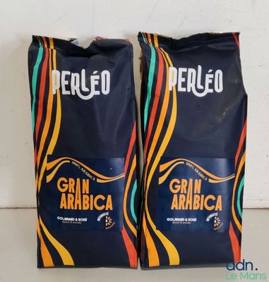 two bags of coffee sitting on top of a counter next to each other