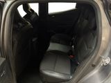 the back seat of a car with the door open and the driver ' s seat down