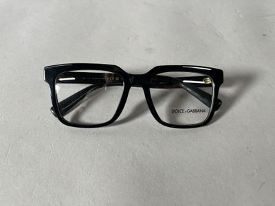 a close up of a pair of glasses on a white surface