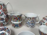 many different types of cups and saucers on the table