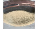a metal bowl with a mixture of flour in it