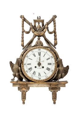 a clock that is sitting on a shelf on a white background