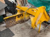 a yellow machine that is sitting in a garage