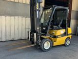 a forklift parked in front of a building