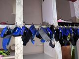many pairs of socks hanging on a rack in a room