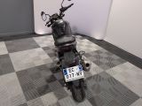 a motorcycle that is parked in a room with a checkered floor