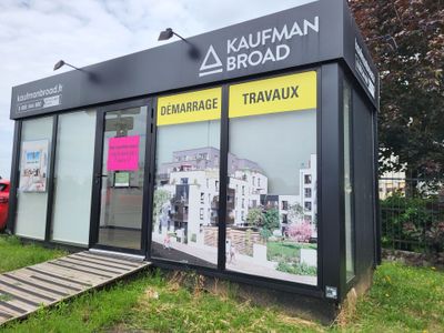a small black building with a sign on the side of it