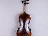 an old violin sitting on top of a white surface