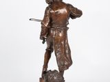 a bronze statue of a man holding a rifle and a dog