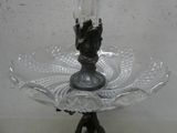 a glass plate with a candle on it on a stand