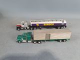 two toy trucks that are sitting next to each other
