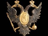 a close up of a gold eagle with a crown on it ' s head
