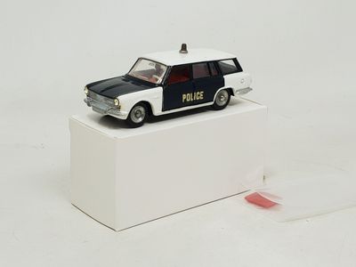 a toy police car sitting on a white box