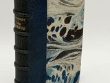 a close up of a book on a white surface with a blue cover