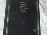 a black book on a table with a pink sticker on it