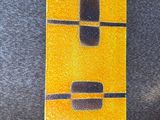 a yellow and black sign on the wall next to a speaker