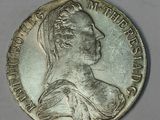 an old silver coin with a woman ' s head on it