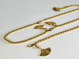 une photo d'un collier en or orné d'un pendentif en forme d'éventail