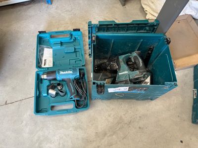 a blue tool box with tools in it on the floor