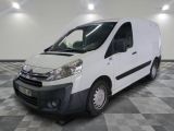 the white van is parked on a checkered floor in a room