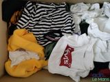 a box full of clothes that is sitting on the floor
