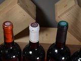 several bottles of wine are lined up in a row on a table