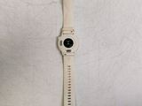 a white watch with a black face on a white surface