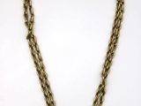 a gold chain necklace with a heart charm on it