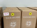 several boxes of wine are stacked on the floor next to each other