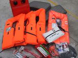 a lot of life vests and other items on the ground