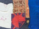 several different types of cloths laid out on a black surface